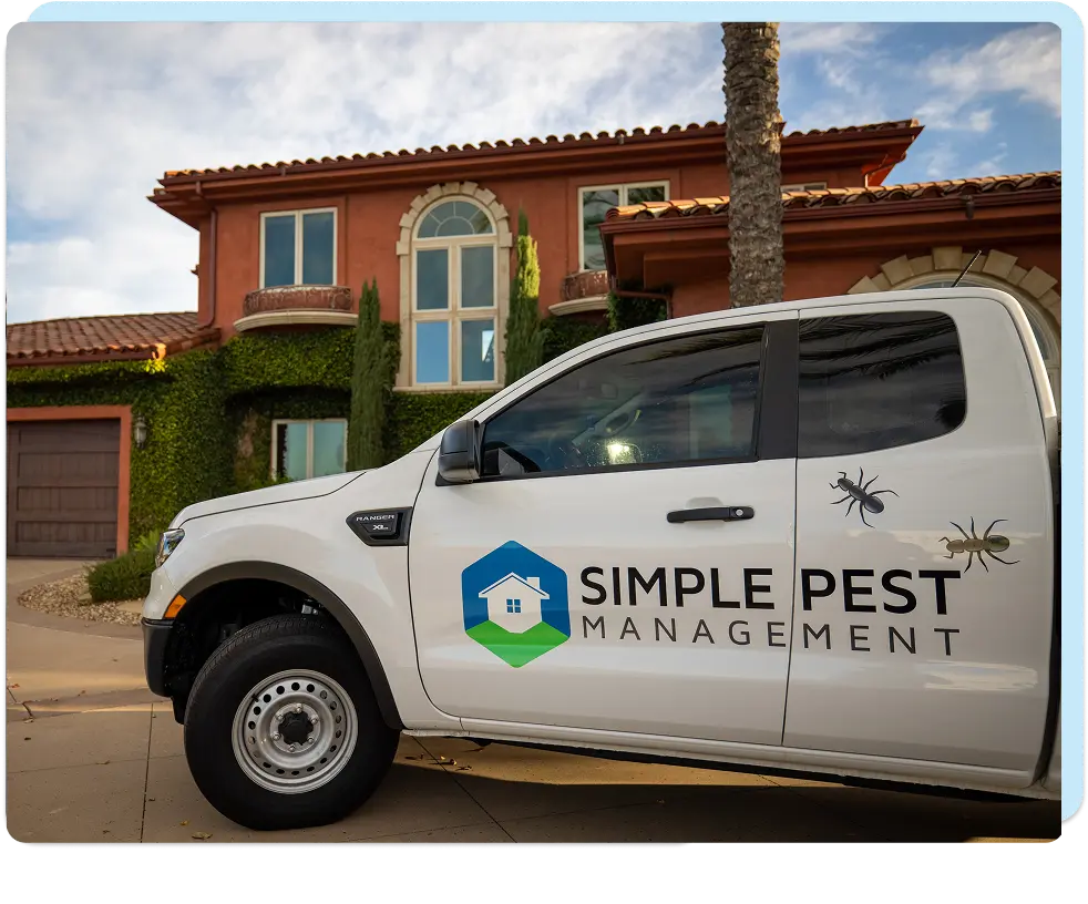 simple pest technician truck in front of home